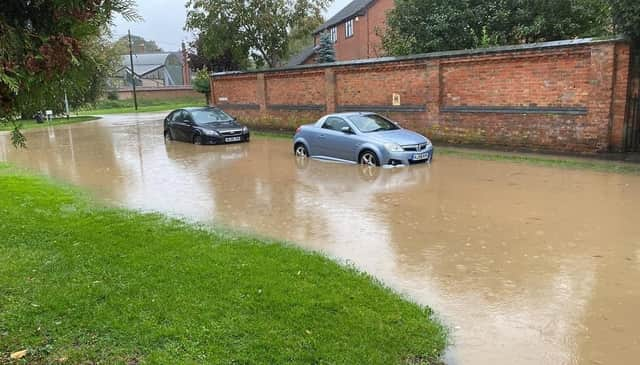 Cars struggle in flooded Mill Lane at Rearsby today