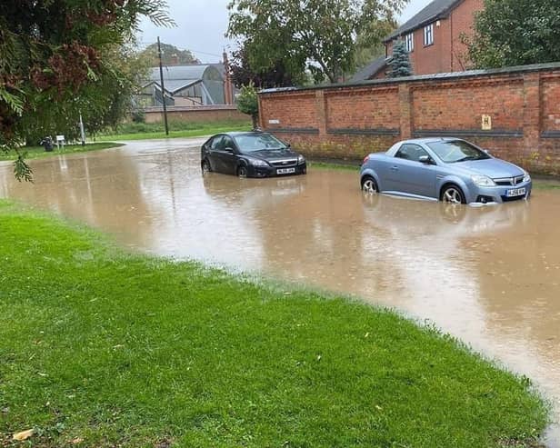 Cars struggle in flooded Mill Lane at Rearsby today