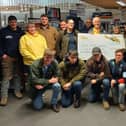 Members of Melton Mowbray Young Farmers Club present a cheque to the air ambulance from their tractor run