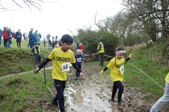 Thrussington School pupils plough through the mud at this year's fun run