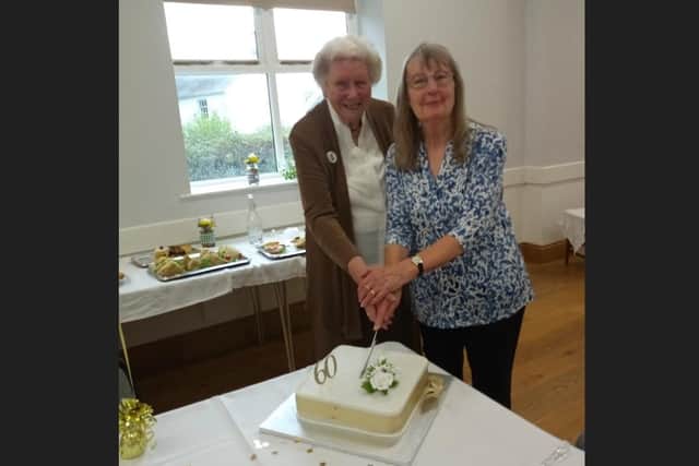 A cake is cut by founder member Mary Moore (left) and chairwoman Judith Bramall as Thorpe Arnold Ladies Group celebrates its 60th anniversary