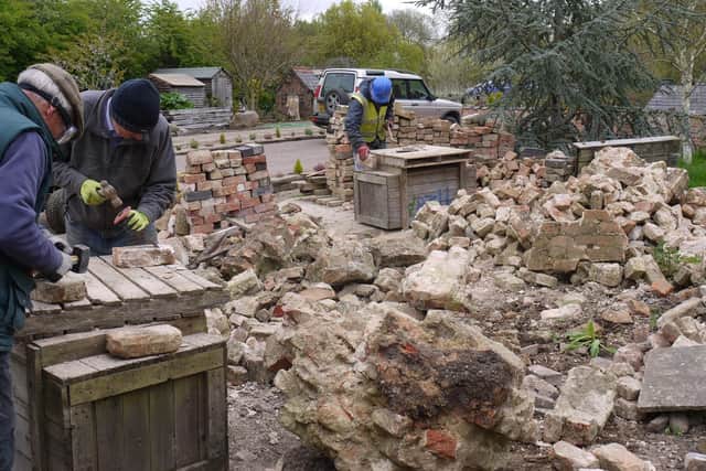 MOWS volunteers cleaning bricks to repair the walls of Thrussington Lock