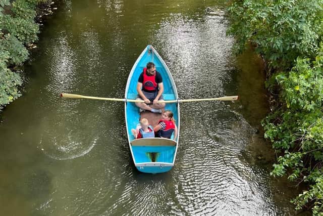 A family enjoys boating around on the River Eye