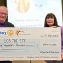 Bill Gregory, president of the Rotary Club of Melton Aurora, presents a cheque for £500 to 103 The Eye's Christine Slomkowska
