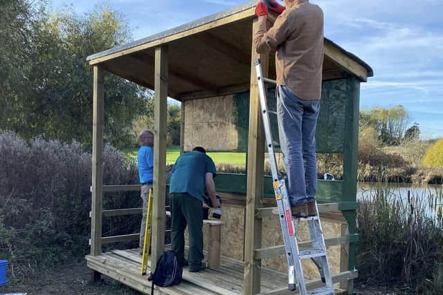 Volunteers construct the new bird hide in Melton Country Park