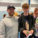 Joshua Singer-Hitchin celebrates his straight grade nines with his parents at Long Field
