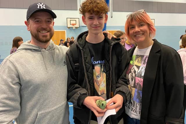 Joshua Singer-Hitchin celebrates his straight grade nines with his parents at Long Field