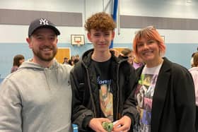 Joshua Singer-Hitchin celebrates his straight grade nines with his parents at Long Field