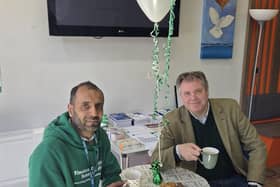 Raj Chavda, at the new dementia-friendly cafe he runs with volunteers, pictured with Melton MP Edward Argar
