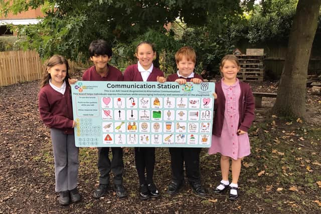 Some of the pupils at Thrussington School with their new communication board