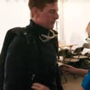 Karen Saunders, of Skydive Langar, checks the parachute equipment for Tom Cruise during filming for Mission Impossible: Dead Reckoning
