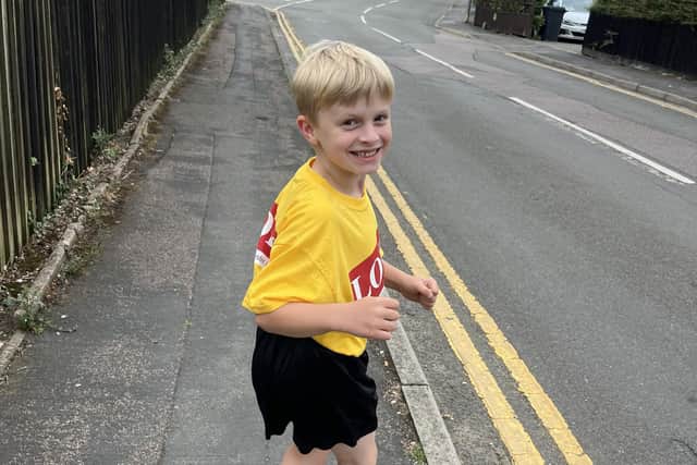 Joey heads off on another daily one-mile run with mum Helayna Ingham following behind