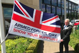 Mayor of Melton, Councillor Alan Hewson, pictured with the Armed Forces Day flag this morning