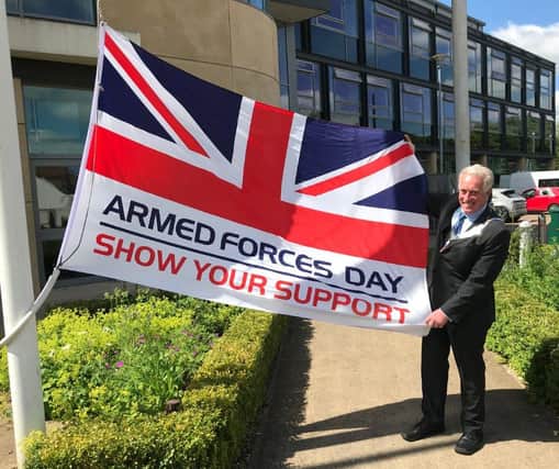 Mayor of Melton, Councillor Alan Hewson, pictured with the Armed Forces Day flag this morning