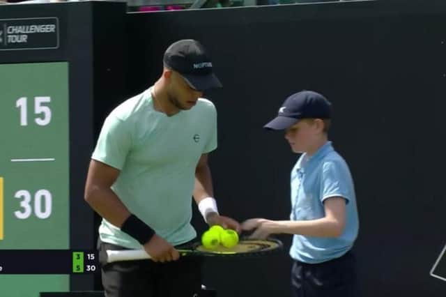 Toby Park working as a ballboy during a match in the Nottingham Tennis Open