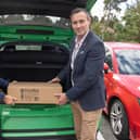County councillor Adam Tilbury allocating Floodsax materials as part of the flood-prevention scheme to Blaby parish councillor Sue Jordan