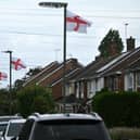 St George's Cross flags flying from lamp posts outside houses on a residential street in Stanwell, west London in August 2025 (Photo by JUSTIN TALLIS / AFP) (Photo by JUSTIN TALLIS/AFP via Getty Images)