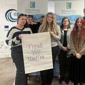 AMY Council members thank Trumpton for funds raised to support their volunteering efforts