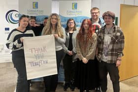 AMY Council members thank Trumpton for funds raised to support their volunteering efforts