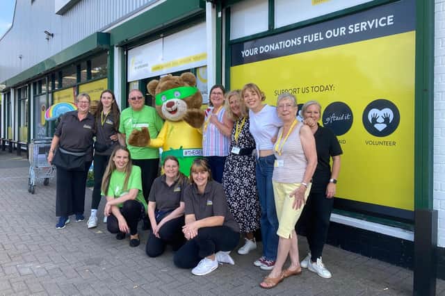 Staff and volunteers, with mascot Blade, outside The Hanger, Melton's charity superstore for the air ambulance store