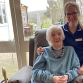 Emily Faulks, Dove Cottage Day Hospice's deputy manager, with a guest sitting on one of the new 'rise and recline' chairs