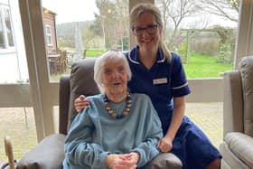 Emily Faulks, Dove Cottage Day Hospice's deputy manager, with a guest sitting on one of the new 'rise and recline' chairs