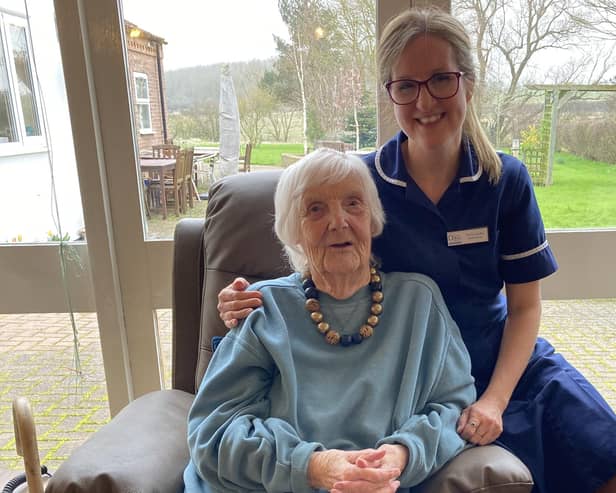 Emily Faulks, Dove Cottage Day Hospice's deputy manager, with a guest sitting on one of the new 'rise and recline' chairs