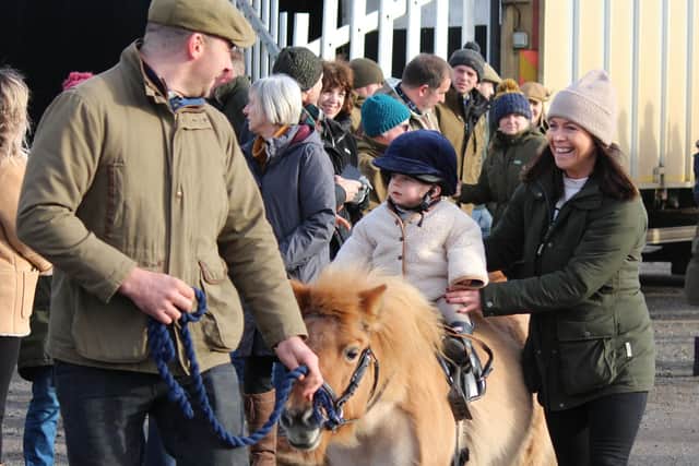 A toddler rides a pony at the Melton Mowbray gathering
