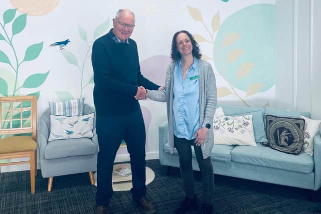David Alcraft, lodge charity steward for the St Mary’s Freemasons Lodge, presenting the donation to centre manager Jenny Hendry at Melton's Pepper's - A Safe Place