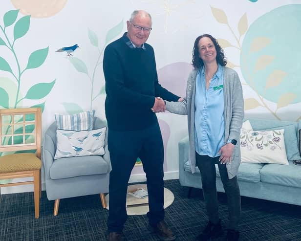 David Alcraft, lodge charity steward for the St Mary’s Freemasons Lodge, presenting the donation to centre manager Jenny Hendry at Melton's Pepper's - A Safe Place
