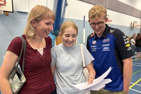 Sophie Wardle-Millar excitedly checks out her GCSE grades with her mum and brother