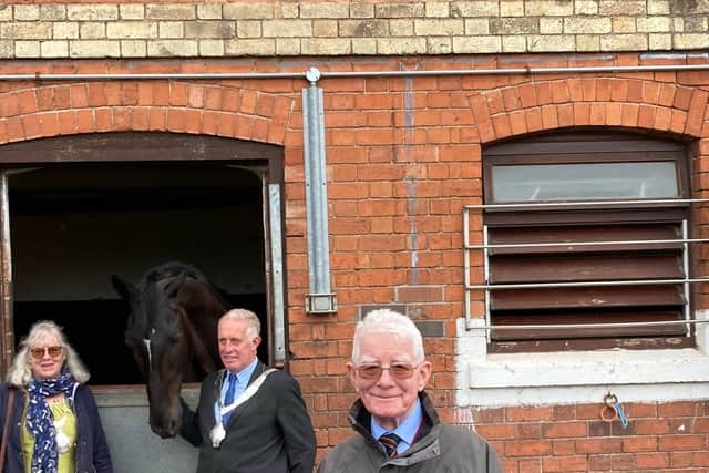 RAVC veteran Peter Roffey under the Green Plaque unveiled at the historic Melton military stables