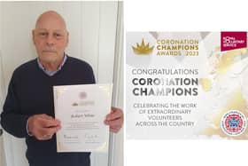 Bob White shows off his certificate after being recognised as a Coronation Champion