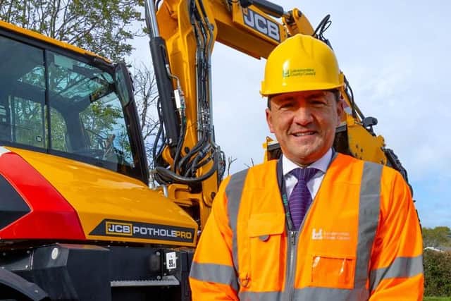 Councillor Hamilton-Gray with the pothole machine being trialled
