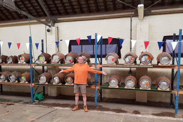Kevin Billsom, of the local CAMRA branch, surveys barrels of beer ready for Melton beer festival
