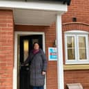 Councillor Butcher outside Melton Council's new house in the town