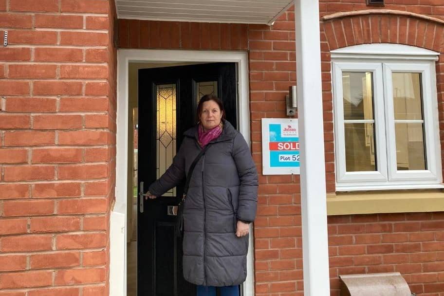 Councillor Butcher outside Melton Council's new house in the town