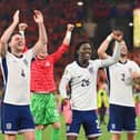 Declan Rice, Kobbie Mainoo and Luke Shaw celebrate after England beat the Netherlands during the UEFA EURO 2024 semi-final match.