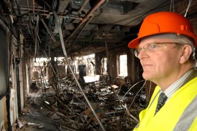 Malise Graham, the then council leader, examines the devastating fire at the Melton Council offices in 2008