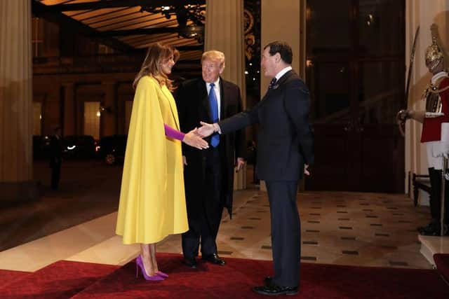 LONDON, ENGLAND - DECEMBER 03: U.S. President Donald Trump and his wife First Lady of the United States Melania Trump are greeted by Deputy Master of The Household Lt Col Anthony Charles Richards as they arrive at a reception for NATO leaders hosted by Queen Elizabeth II at Buckingham Palace on December 3, 2019 in London, England. Her Majesty Queen Elizabeth II hosted the reception at Buckingham Palace for NATO Leaders to mark 70 years of the NATO Alliance. (Photo by Dan Kitwood-WPA Pool/Getty Images)