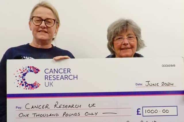 Belvoir Big Band's Dr Liz Pearce (right) presents cheque to Cancer Research UK's Becky Elphick