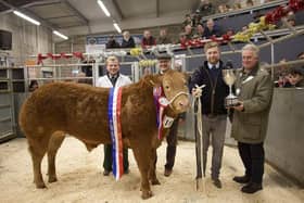 JB Thompson of Stainby are presented with The Brownlow Challenge Cup, for Champion Beast last year's Melton Fatstock Show, by the Mayor of Melton, Councillor Alan Hewson, Melton & Belvoir Agricultural Society chair, Hugh Brown, and auctioneer, Scott Ruck