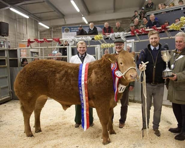 JB Thompson of Stainby are presented with The Brownlow Challenge Cup, for Champion Beast last year's Melton Fatstock Show, by the Mayor of Melton, Councillor Alan Hewson, Melton & Belvoir Agricultural Society chair, Hugh Brown, and auctioneer, Scott Ruck