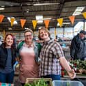 Some of the team at Melton's Pepper's - A Safe Place promote their activities on a market stall
