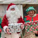 Santa and his elves pictured outside their grotto in The Bell Centre, Melton, today
