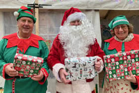 Santa and his elves pictured outside their grotto in The Bell Centre, Melton, today