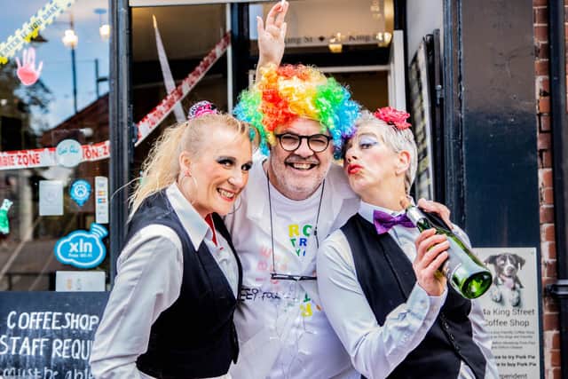 Melton cafe owner Nigel Keep with some of the street entertainers who thrilled the crowds at the Melton Madness festival