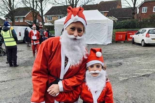 Sara Wilson-Wright and her daughter Isabelle pictured at the start of Sunday's Melton Santa Fun Run in the country park