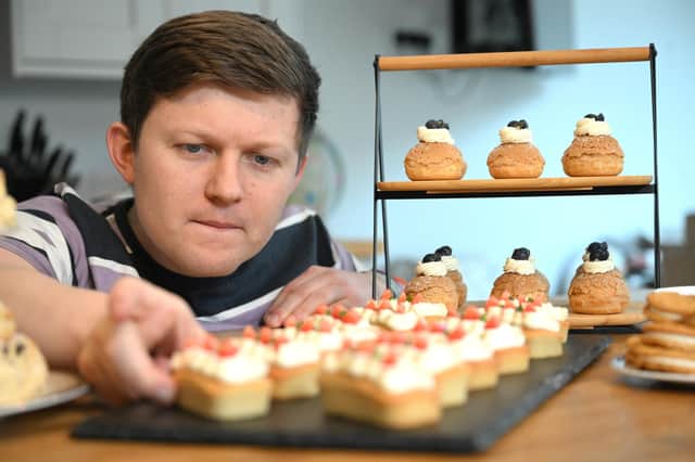 Great British Bake Off star Josh Smalley shows off his celebratory cakes for Belvoir Farm's 40th birthday