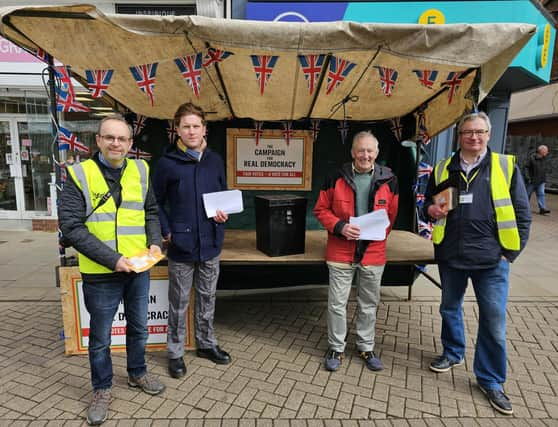 Members of the local Liberal Democrats, Labour and Green Party man a stall in Melton's Market Place to highlight changes to voter ID regulations for the upcoming local elections